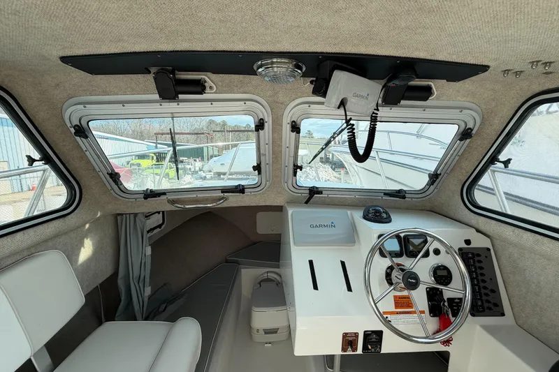 Slide: The Image of Interior of a 2015 Parker 2120 boat with Garmin navigation system and steering wheel. - 12
