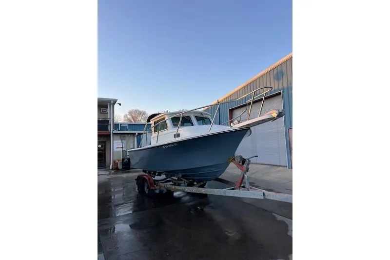 Slide: The Image of 2015 PARKER BOATS 2120 on trailer outside industrial building. - 6