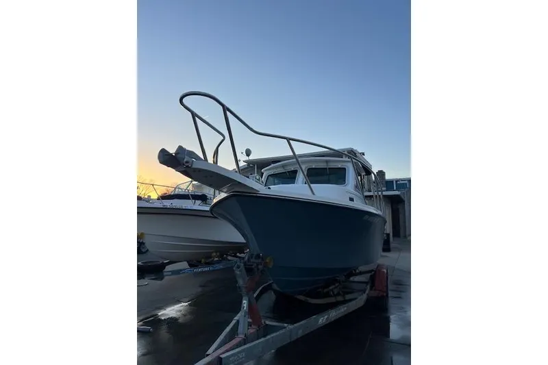 Slide: The Image of 2015 Parker Boats 2120 on trailer at sunset, ready for adventure. - 7