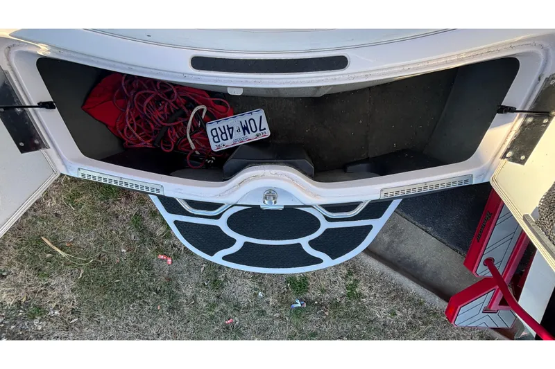 Slide: The Image of Open storage compartment of 2006 Nautique Ski Nautique 206 with ropes and a license plate. - 10