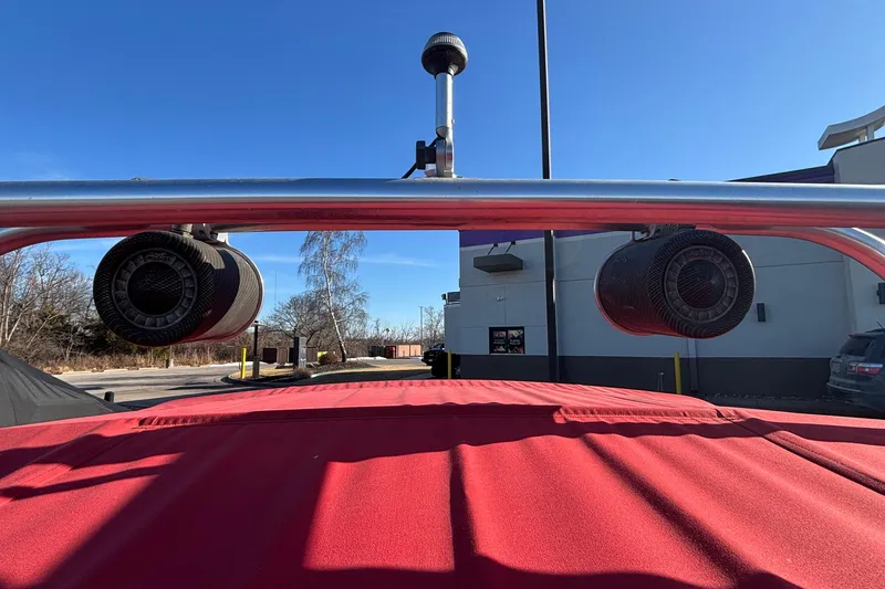 Slide: The Image of 2006 Nautique Ski Nautique 206 with red cover and mounted speakers, sunny day. - 13