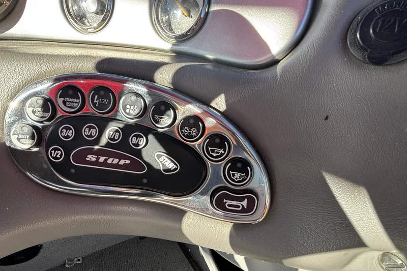 Slide: The Image of Control panel of a 2006 Nautique Ski Nautique 206 boat with various buttons. - 16
