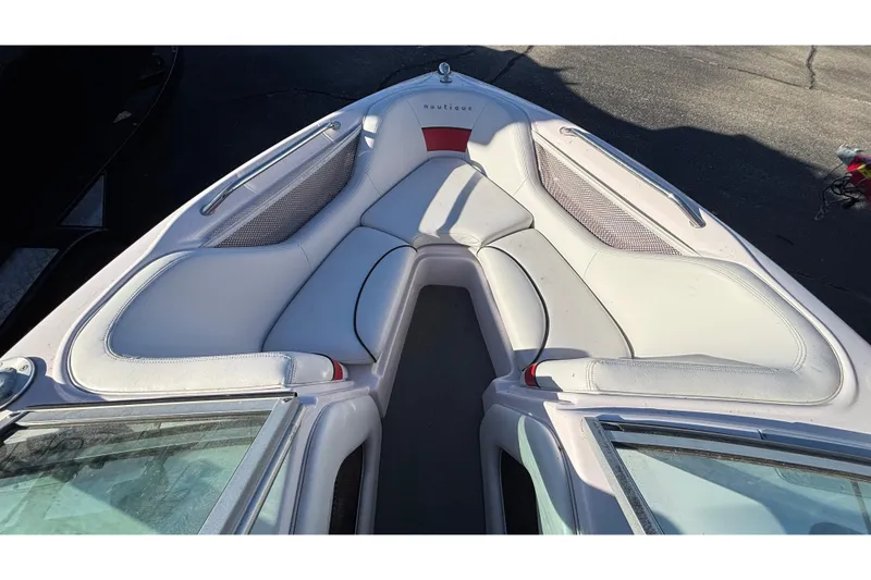 Slide: The Image of 2006 Nautique Ski Nautique 206 boat interior with white seating and red accents. - 21