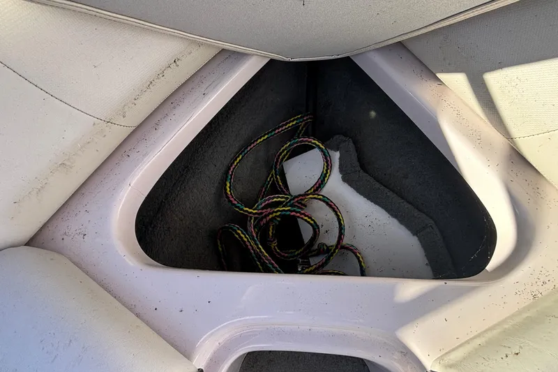 Slide: The Image of 2006 Nautique Ski Nautique 206 boat storage compartment with colorful rope inside. - 24