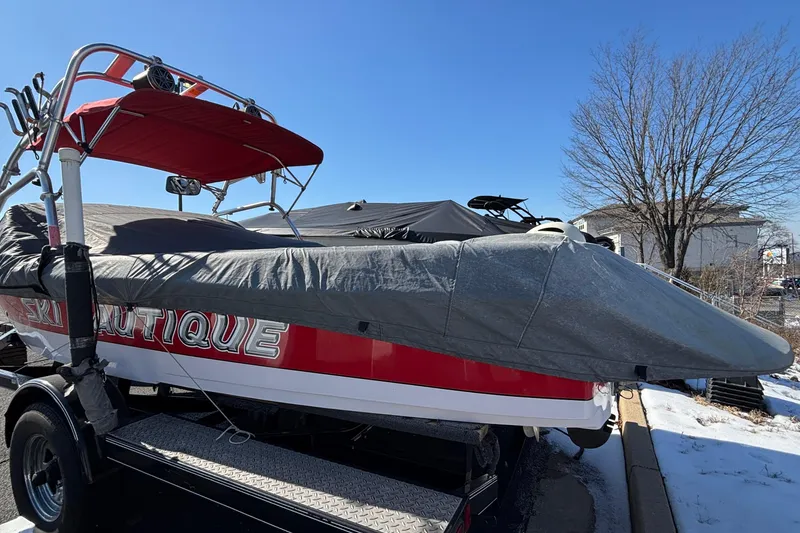 Slide: The Image of 2006 Nautique Ski Nautique 206 boat covered, parked on trailer, sunny winter day. - 28