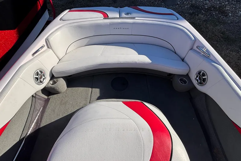 Slide: The Image of 2006 Nautique Ski Nautique 206 boat interior with white and red seating, speakers, and cup holders. - 6