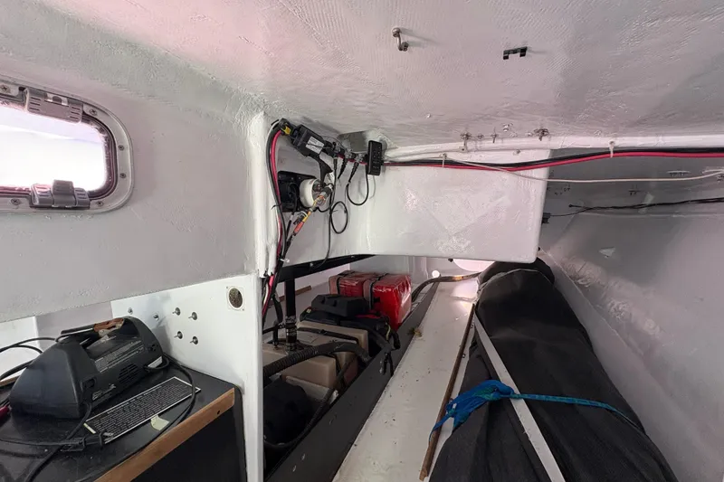 Slide: The Image of Interior of Antrim 40 sailboat showing wiring, equipment, and storage area. - 20