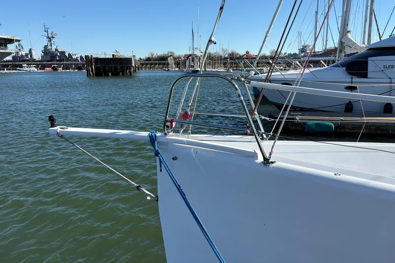Slide: The Image of Bow of Antrim 40 sailboat docked in a marina with other vessels. - 4