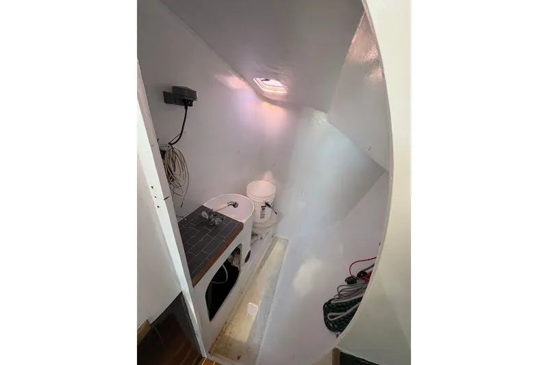 Slide: The Image of Compact bathroom interior of Antrim 40 sailboat with sink, toilet, and storage space. - 17