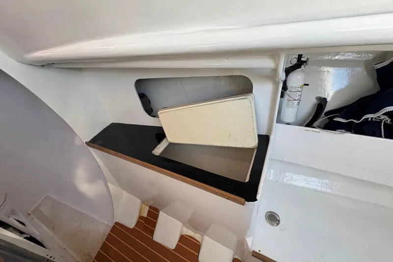 Slide: The Image of Interior of Antrim 40 sailboat with storage compartment and fire extinguisher. - 16