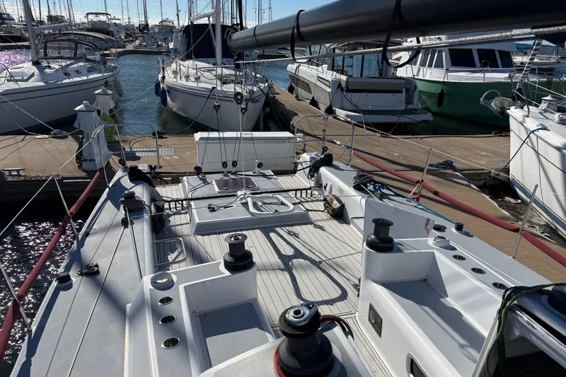 Slide: The Image of Antrim 40 sailboat docked at marina, surrounded by other boats under clear skies. - 7