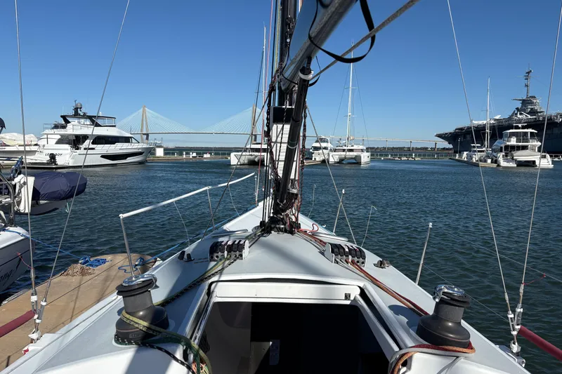 Slide: The Image of Sailboat Antrim 40 docked in marina with bridge and yachts in background. - 5