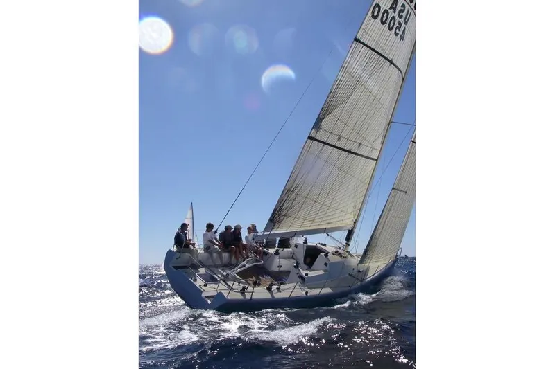 Slide: The Image of Sailing yacht Antrim 40 navigating ocean waters under clear blue skies. - 25