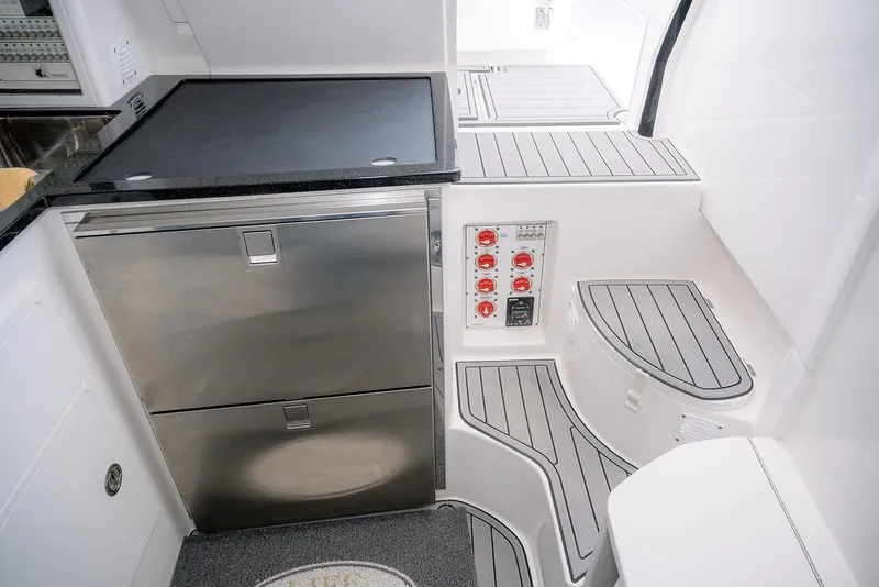 Slide: The Image of 2022 Contender 39 Fisharound interior with stainless steel appliances and control panel. - 10