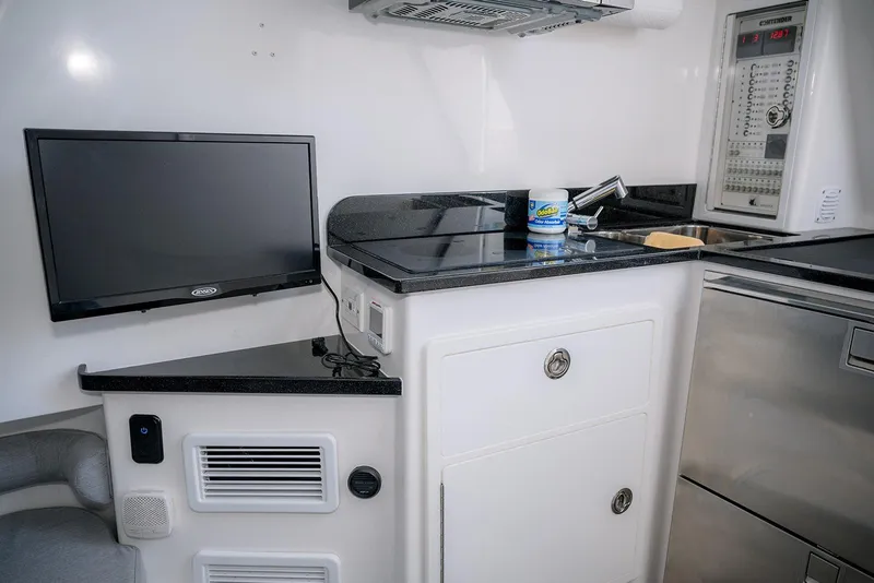 Slide: The Image of 2022 Contender 39 Fisharound interior with TV, sink, and control panel. - 11