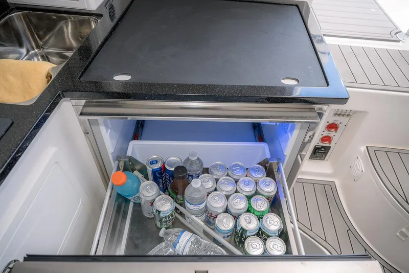 Slide: The Image of Refrigerator drawer on 2022 Contender 39 Fisharound boat, stocked with drinks and beverages. - 13