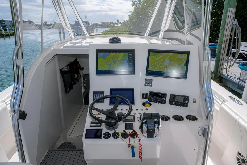 Slide: The Image of 2022 Contender 39 Fisharound boat cockpit with advanced navigation systems and controls. - 15