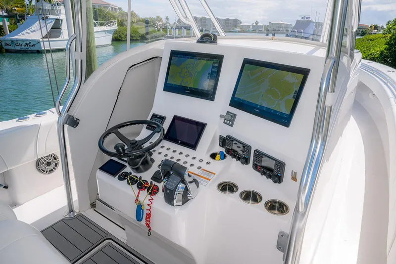 Slide: The Image of 2022 Contender 39 Fisharound boat cockpit with advanced navigation displays and controls. - 17