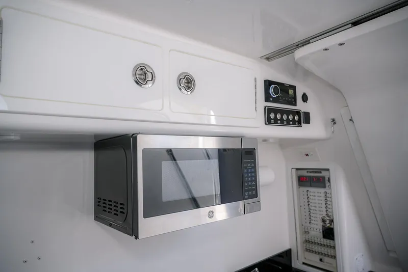 Slide: The Image of Interior of 2022 Contender 39 Fisharound featuring microwave and control panel. - 19