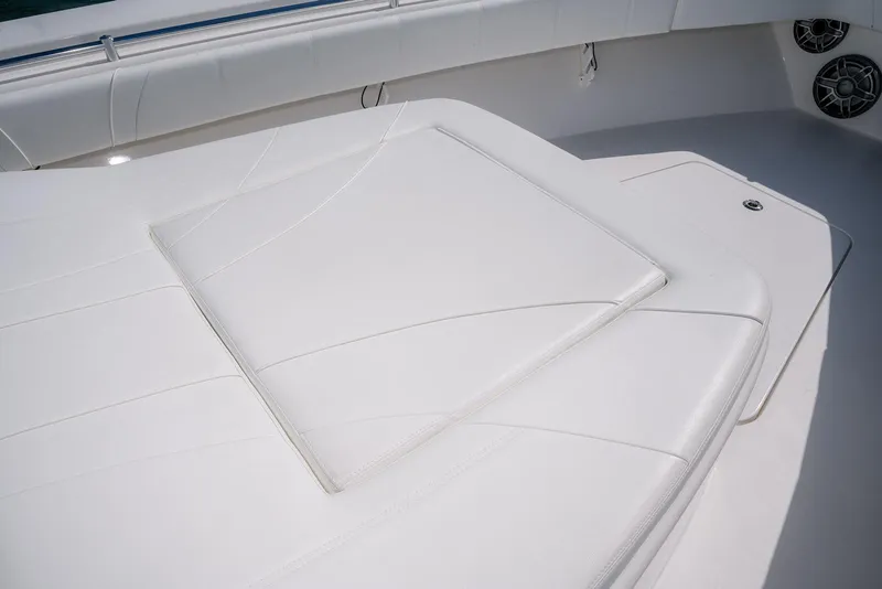 Slide: The Image of 2022 Contender 39 Fisharound boat with sleek white seating and modern design. - 21