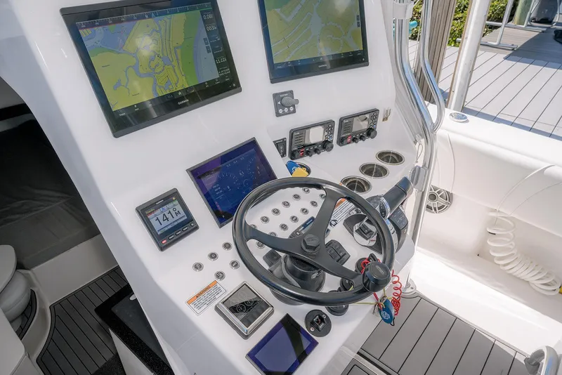 Slide: The Image of 2022 Contender 39 Fisharound helm with advanced navigation displays and controls. - 27