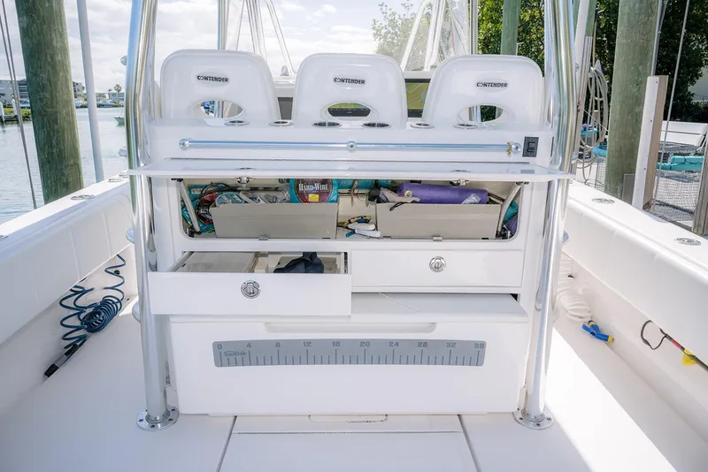 Slide: The Image of 2022 Contender 39 Fisharound boat interior with storage compartments and fishing gear. - 30