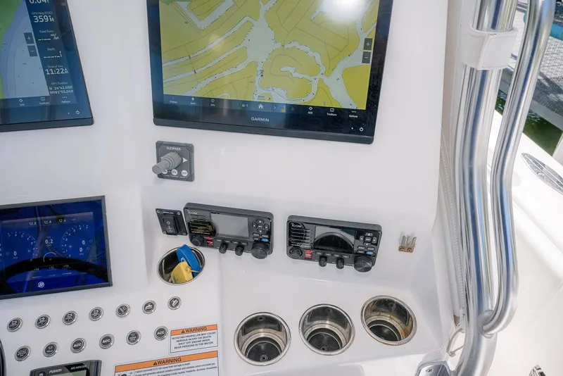Slide: The Image of 2022 Contender 39 Fisharound dashboard with Garmin navigation and control panels. - 31