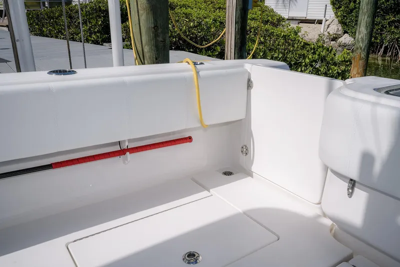 Slide: The Image of 2022 Contender 39 Fisharound boat interior with white seating and fishing rod holder. - 32