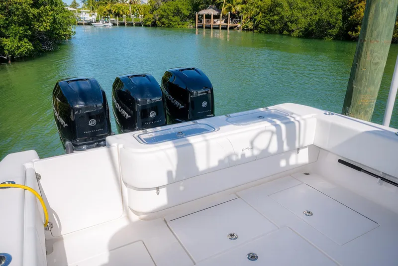 Slide: The Image of 2022 Contender 39 Fisharound boat with triple Mercury outboard engines on a calm waterway. - 37