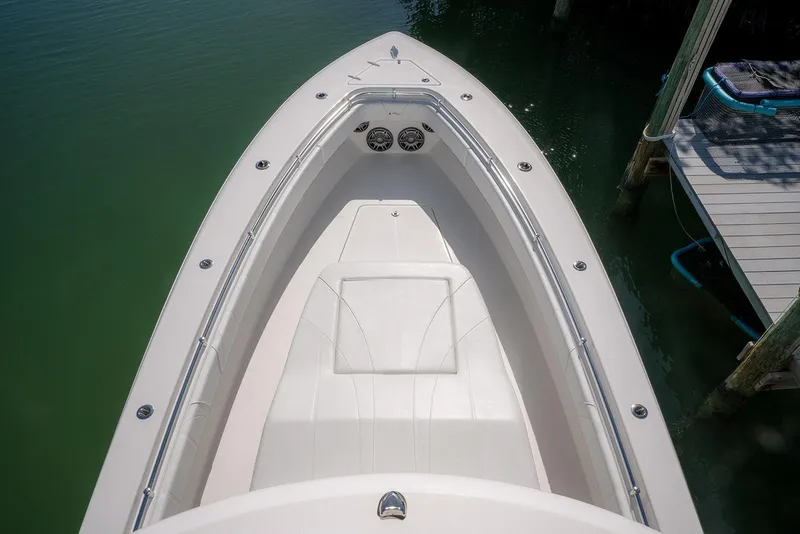 Slide: The Image of 2022 Contender 39 Fisharound boat bow view at dock, featuring sleek design and spacious seating. - 49