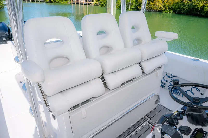 Slide: The Image of 2022 Contender 39 Fisharound boat with luxurious white seating and steering area. - 51