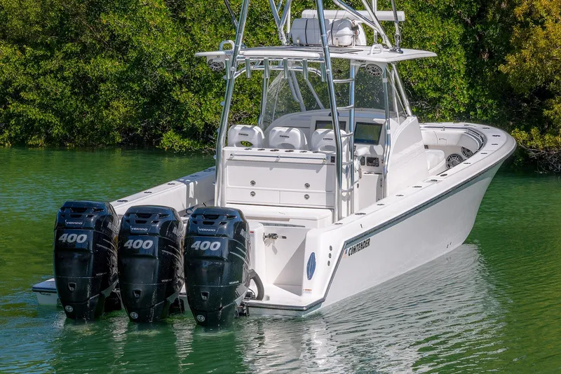 Slide: The Image of 2022 Contender 39 Fisharound boat with triple 400 horsepower engines on calm water. - 55