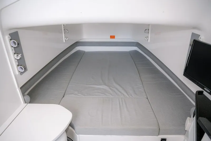 Slide: The Image of 2022 Contender 39 Fisharound cabin interior with bed and TV. - 8