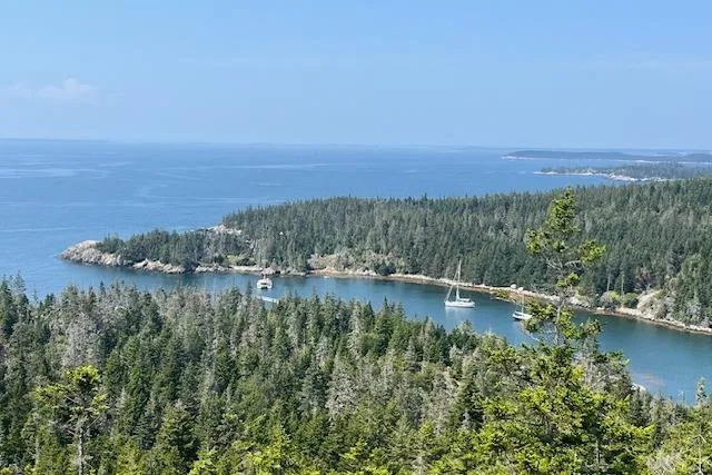 Slide: The Image of Scenic coastal view with Hallberg-Rassy 40C sailboats anchored in a serene bay, 2021. - 10