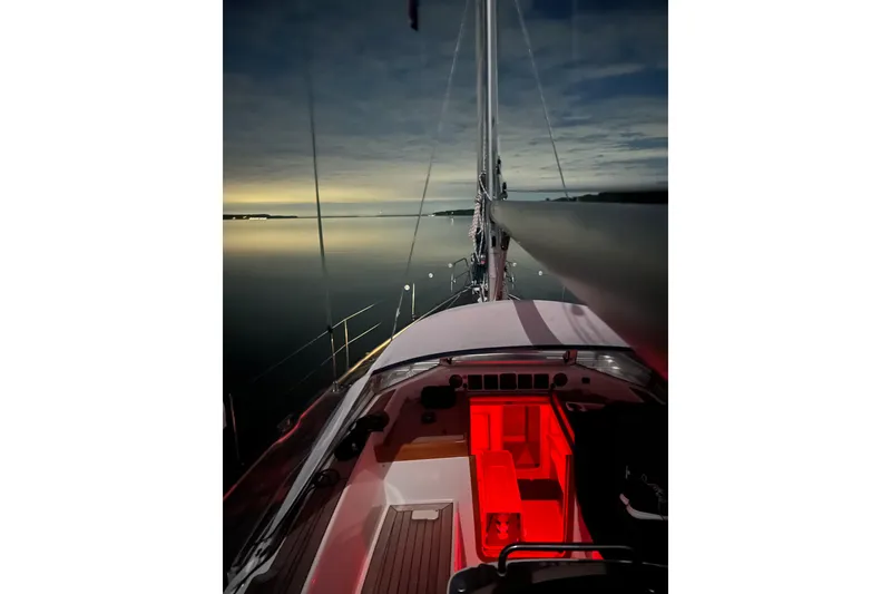 Slide: The Image of Sailing yacht Hallberg-Rassy 40C, 2021 model, illuminated at night on calm waters. - 18