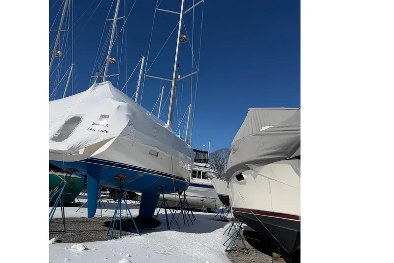 Slide: The Image of 2021 Hallberg-Rassy 40C sailboat in winter storage, covered and elevated on stands. - 19