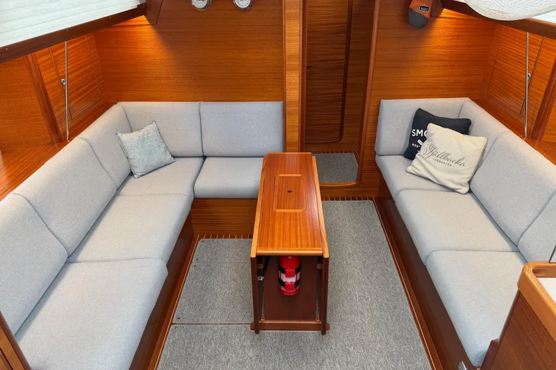Slide: The Image of Interior of 2021 Hallberg-Rassy 40C yacht with cozy seating and wooden table. - 22
