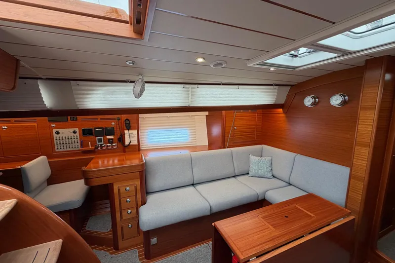 Slide: The Image of Luxurious interior of 2021 Hallberg-Rassy 40C yacht with elegant wood finish and cozy seating. - 25