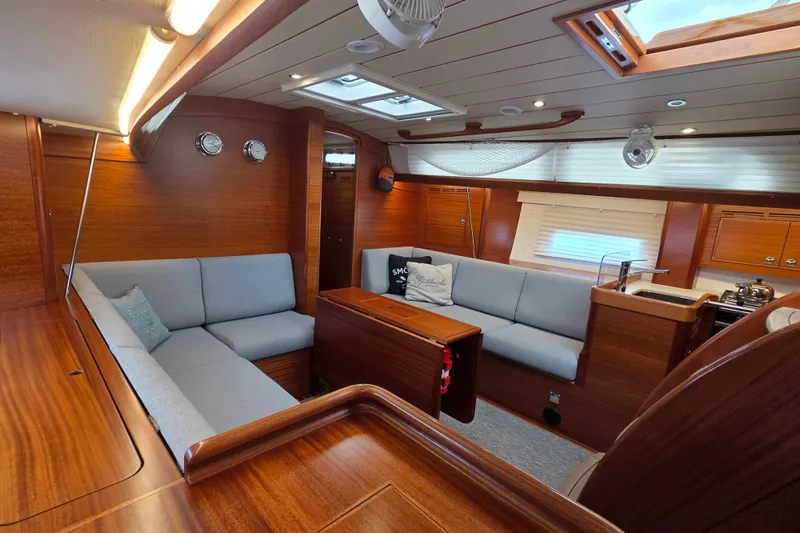 Slide: The Image of Luxurious 2021 Hallberg-Rassy 40C yacht interior with elegant wood finish and comfortable seating. - 27