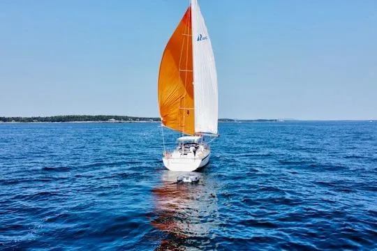Slide: The Image of Sailing yacht Hallberg-Rassy 40C 2021 with orange sail on open sea. - 3