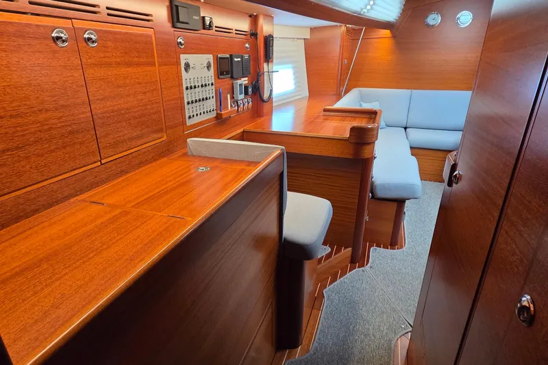 Slide: The Image of Interior of 2021 Hallberg-Rassy 40C yacht with wooden finish and seating area. - 35