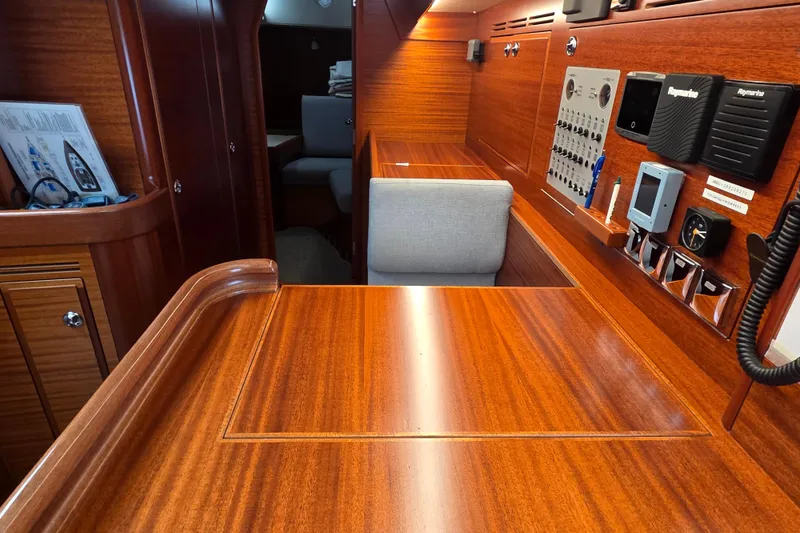 Slide: The Image of Interior of 2021 Hallberg-Rassy 40C yacht with wooden finish and navigation controls. - 36