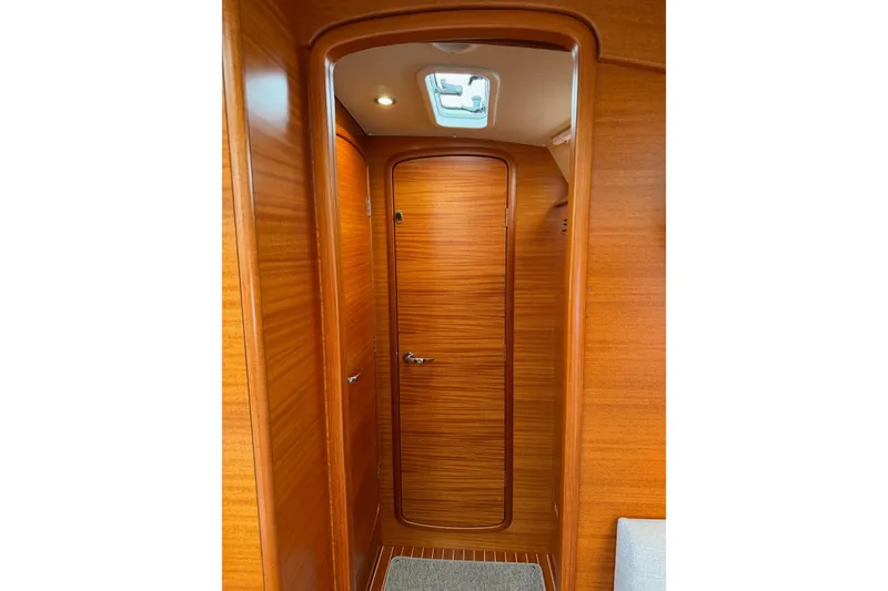 Slide: The Image of Hallberg-Rassy 40C 2021 yacht interior with wooden finish and ceiling light. - 41