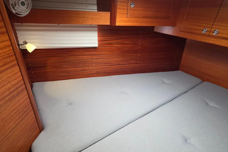 Slide: The Image of Cozy cabin interior of 2021 Hallberg-Rassy 40C yacht with wooden finish and soft bedding. - 48