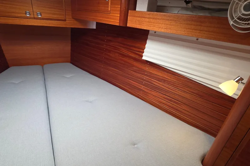 Slide: The Image of Cozy cabin interior of 2021 Hallberg-Rassy 40C yacht with wooden paneling and soft lighting. - 49