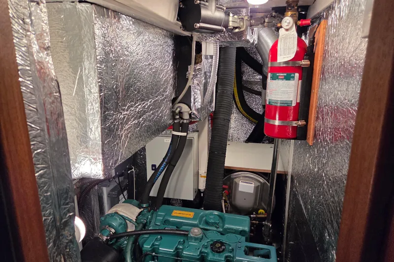 Slide: The Image of Engine room of 2021 Hallberg-Rassy 40C yacht with fire extinguisher and insulation. - 54