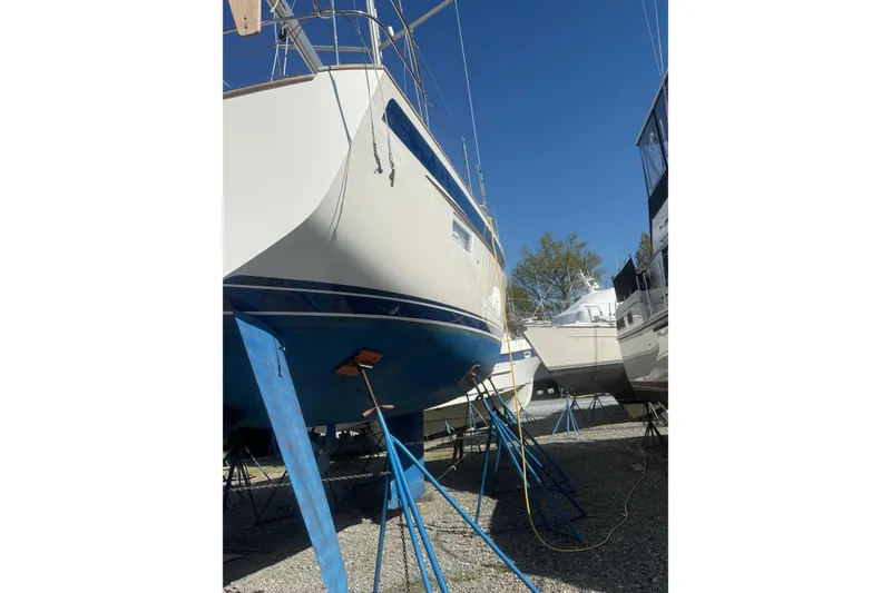 Slide: The Image of Engine room of 2021 Hallberg-Rassy 40C yacht with blue hoses and insulation. - 56