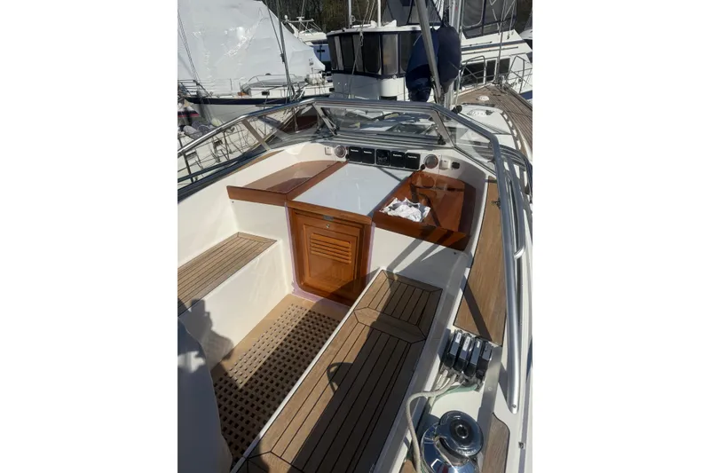 Slide: The Image of 2021 Hallberg-Rassy 40C sailboat on stands, displayed outdoors under clear blue sky. - 59