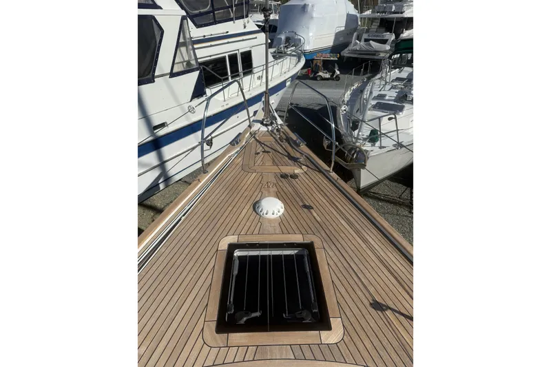 Slide: The Image of Deck view of a 2021 Hallberg-Rassy 40C yacht, showcasing teak wood finish. - 64