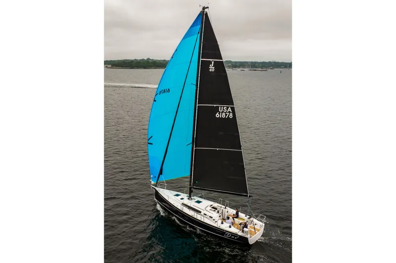Slide: The Image of 2026 J Boats J/40 sailing on open water with blue and black sails. - 11